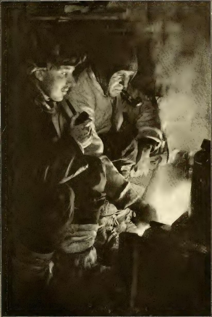 Meares and Capt Oates at the blubber stove cooking food for the dogs