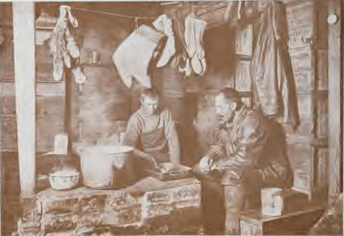 Meares and Dimitri at the blubber stove in the “Discovery” Hut at Hut Point. November 3rd 1911