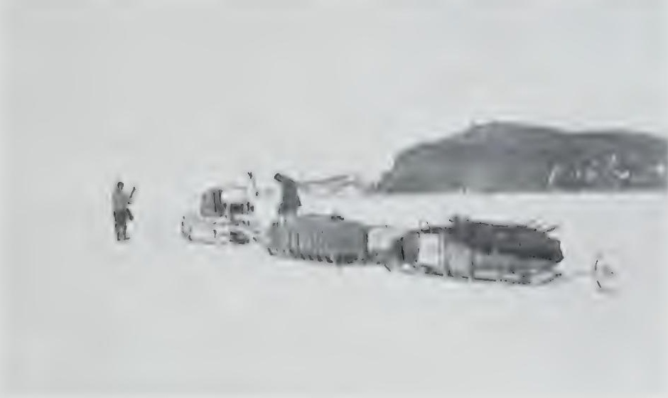 Lieut Evans and Day guide a motor sledge